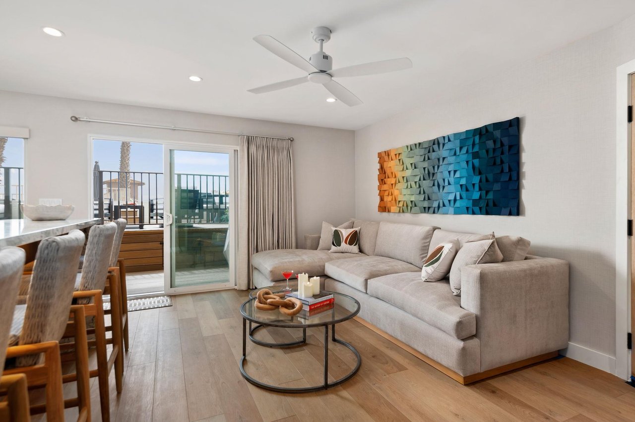 Comfortable living room, couch, extending out to the beachfront deck.