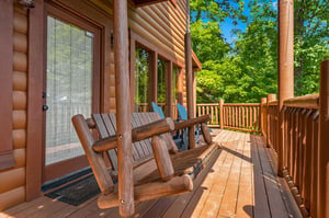 Settle into rustic rocking chairs on your private deck, surrounded by a lush forest canopy. The fresh mountain air and peaceful woodland views create your perfect spot for morning coffee or quiet refl
