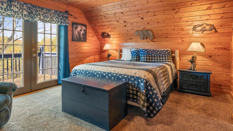 Cozy up in your rustic retreat with warm woodpaneled walls, plush bedding, and charming wildlife touches that create the perfect mountain getaway atmosphere.
