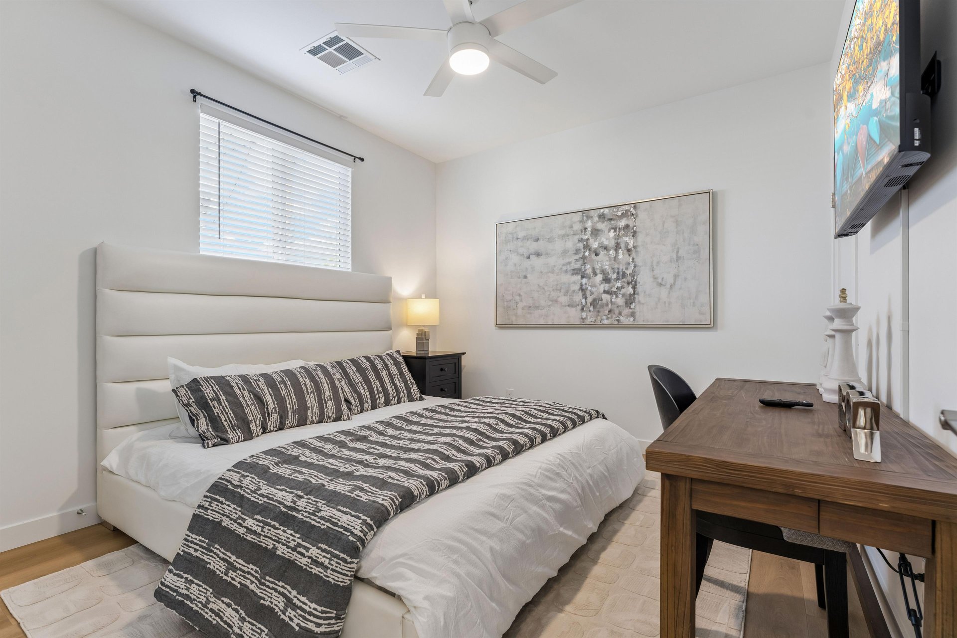 King size bed, desk, and flatscreen TV.