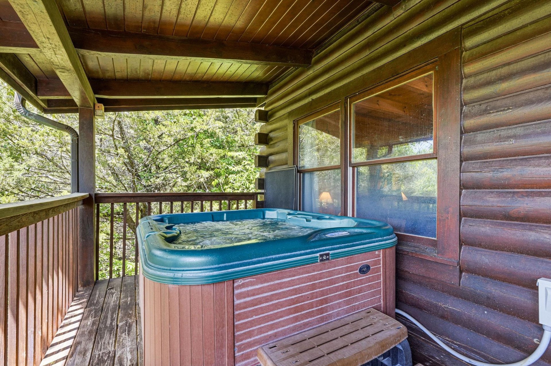 Soak your cares away in your private hot tub on the covered deck, surrounded by lush forest views that make every moment feel like a peaceful woodland escape.