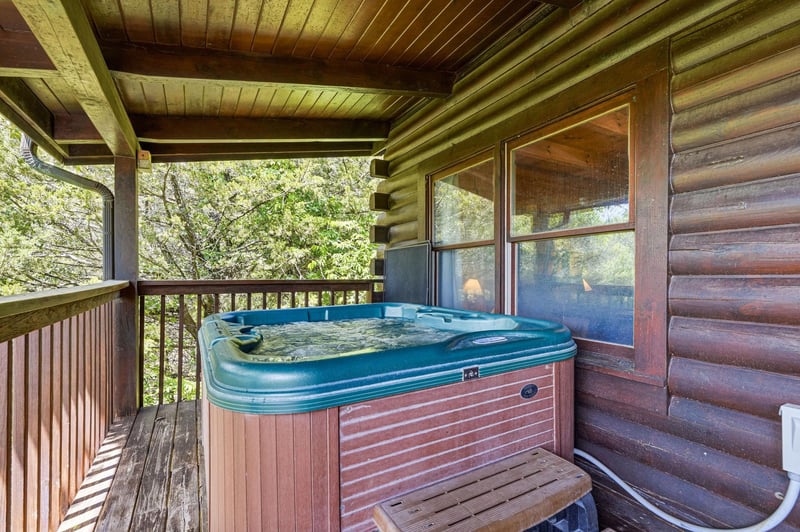 Soak your cares away in your private hot tub on the covered deck, surrounded by lush forest views that make every moment feel like a peaceful woodland escape.