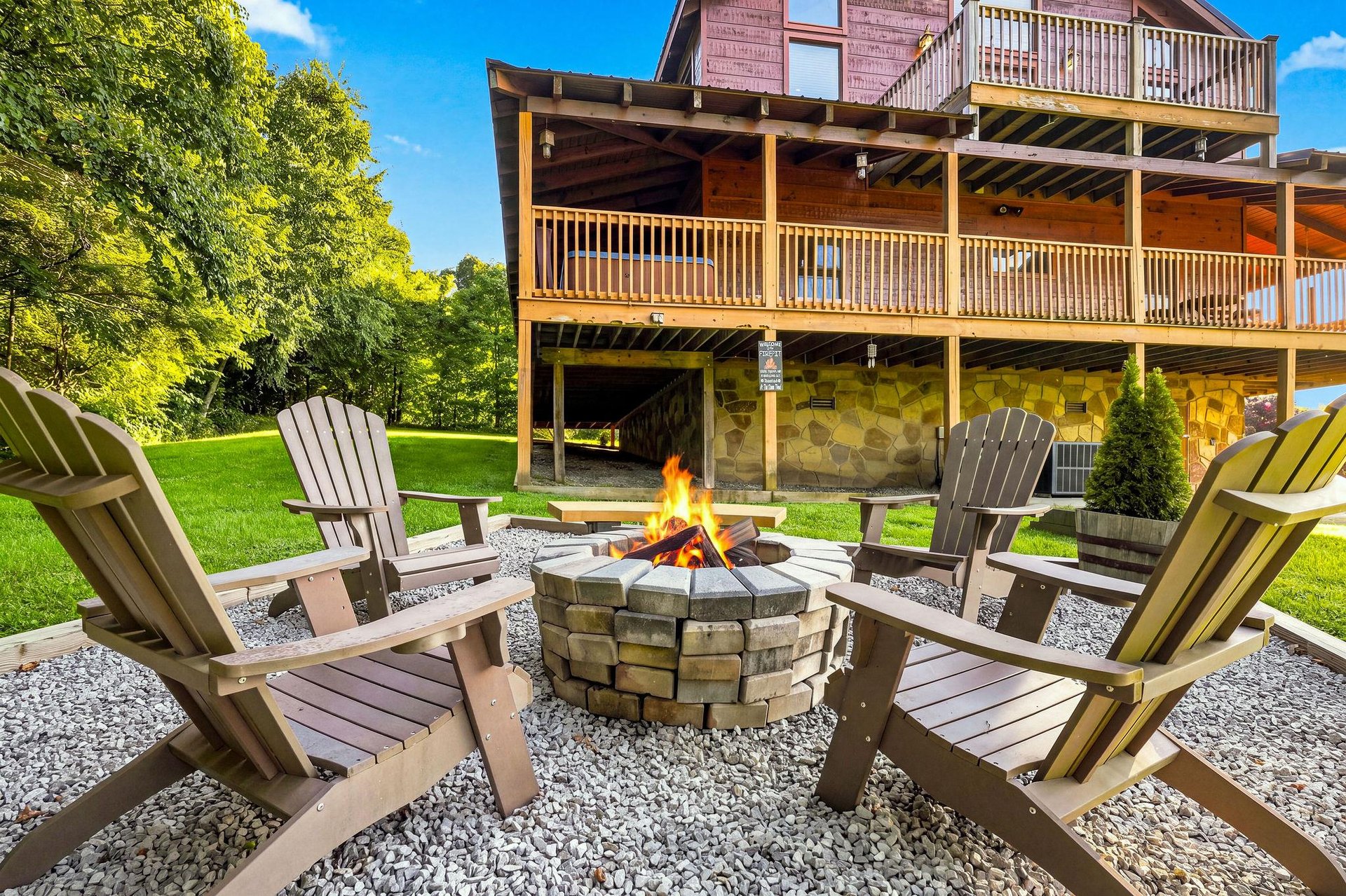 Gather around the fire pit on a sunny afternoon with Adirondack chairs perfectly positioned for storytelling and stargazing, backed by lush lawns and mountain views.