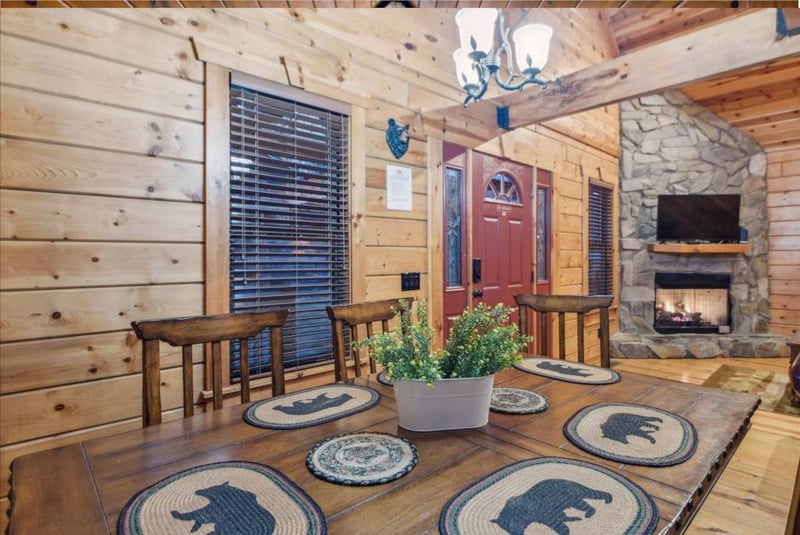 Gather around your rustic dining table where charming bear placemats await your mountain meals by the crackling fireplace.
