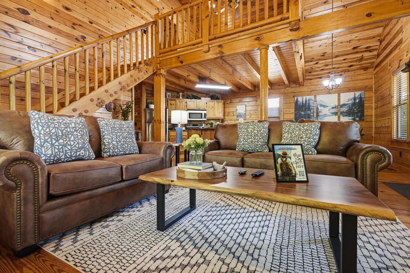 Sink into plush leather sofas surrounded by warm wood beams and rustic charm in your cozy mountain retreat.
