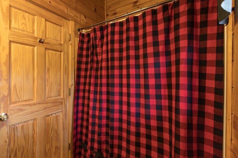 Bathroom with a tub and shower at Hibernation Station, a 3bedroom cabin rental located in Pigeon Forge