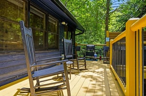 Relax on your private deck surrounded by lush greenery, where morning coffee and evening BBQs feel like a peaceful escape. The rocking chairs and shaded seating invite you to unwind.