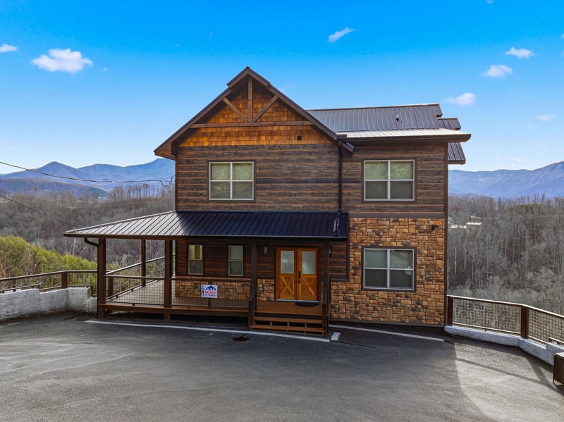 Rustic mountain cabin with stunning panoramic views, featuring natural wood and stone construction set against rolling mountain landscapes.
