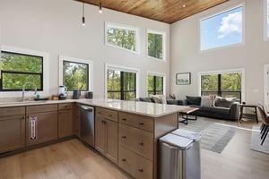 Light floods through floortoceiling windows, framing lush treetop views from your openplan kitchen and living area. High wood ceilings add warmth, while modern touches invite you to cook, relax, an