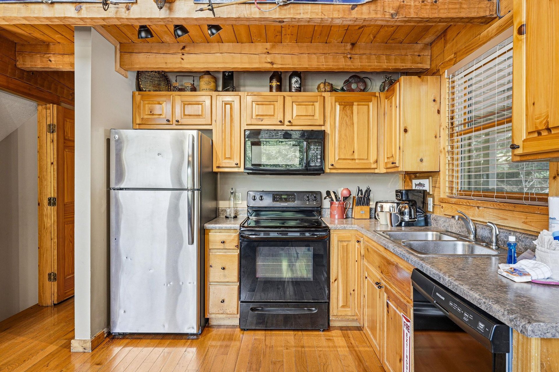 Your fully equipped kitchen features warm wood cabinetry, granite counters, and everything you need to prepare meals during your stay.