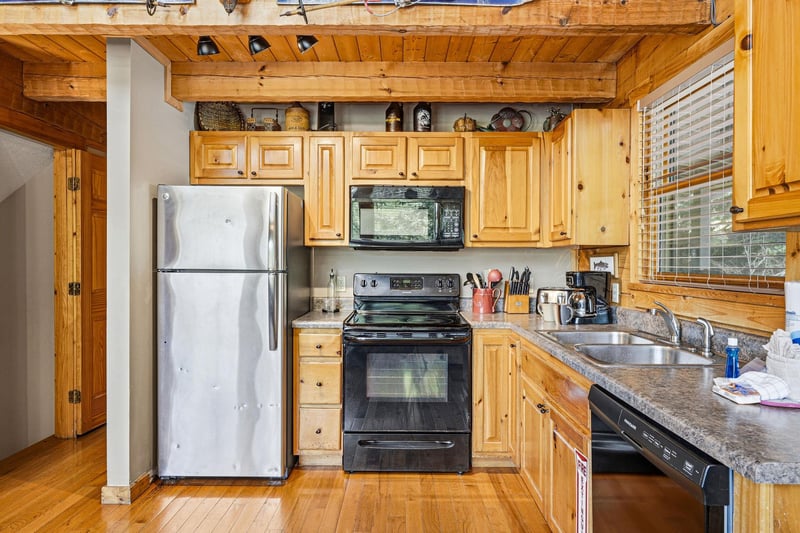 Your fully equipped kitchen features warm wood cabinetry, granite counters, and everything you need to prepare meals during your stay.