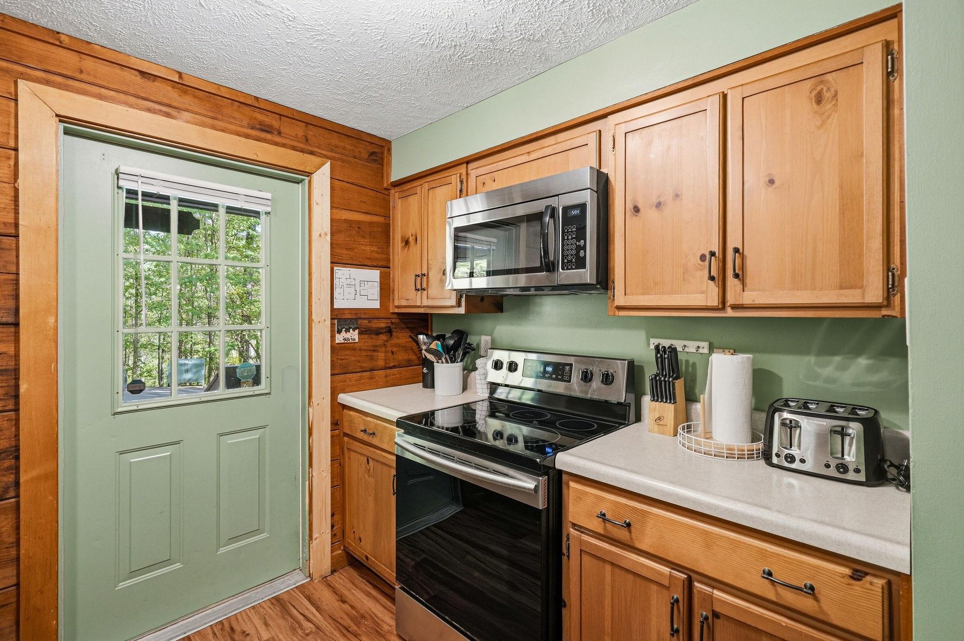 Your fully equipped kitchen features warm wood cabinets and modern appliances, perfect for preparing homecooked meals during your stay.