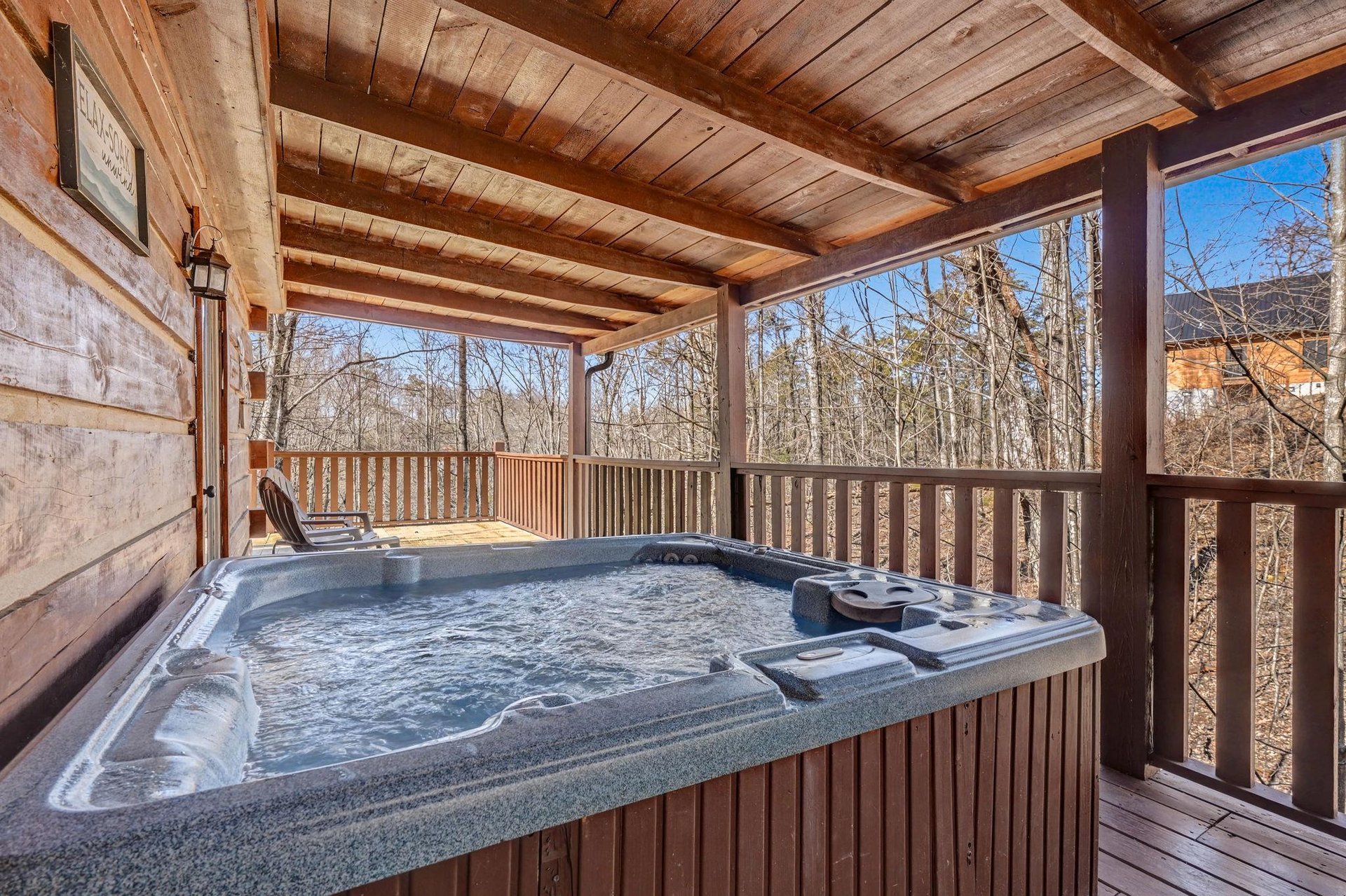 Soak in your private hot tub while enjoying peaceful forest views from this covered deck.