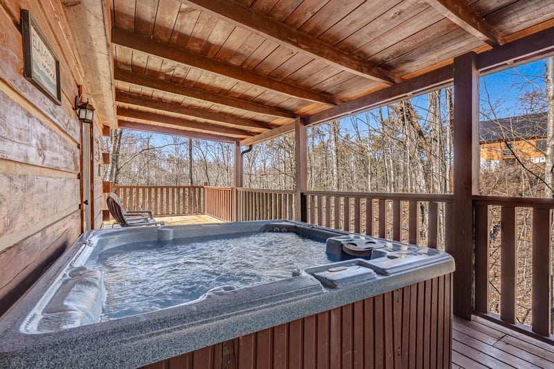 Soak in your private hot tub while enjoying peaceful forest views from this covered deck.