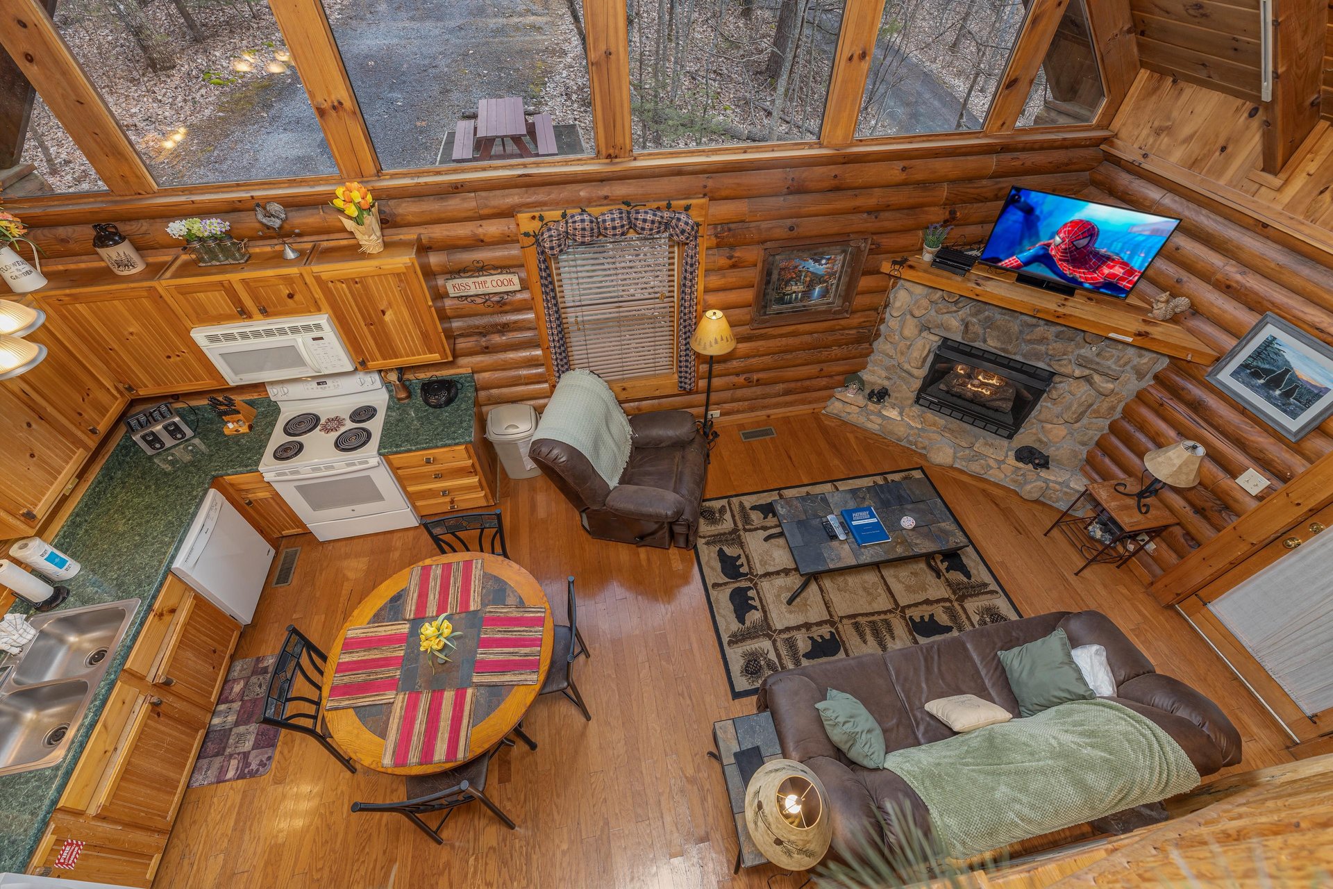 Looking down at the living, dining, and kitchen spaces at A Lovers Secret, a 1 bedroom cabin rental located in Gatlinburg