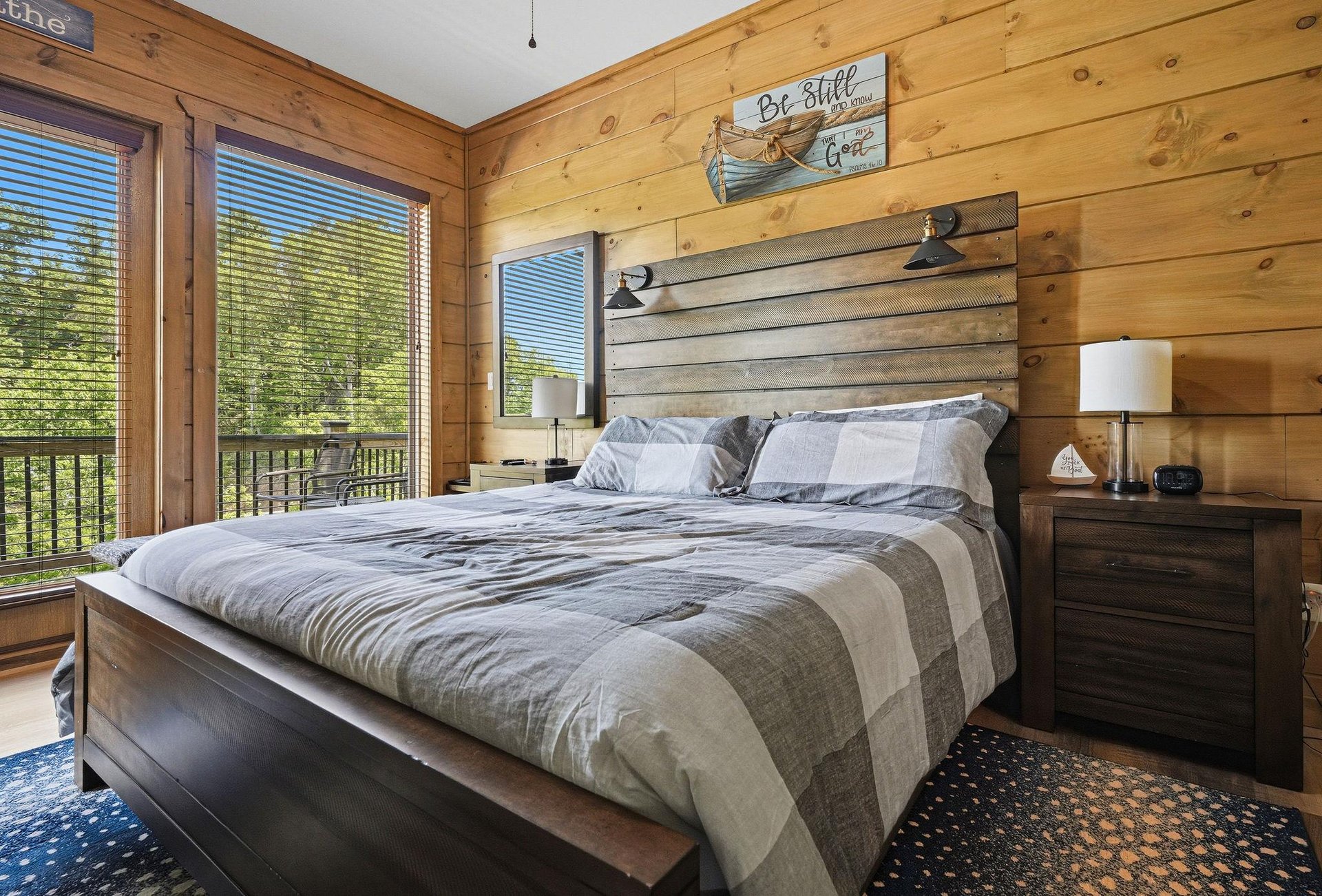 Drift off to sleep in your cozy log cabin bedroom, where rustic charm meets comfort with natural wood walls and peaceful forest views.