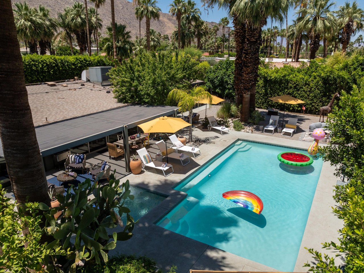 Entertainers backyard with outdoor seating, private pool and spa, sun loungers, cabana, and outdoor dining space.