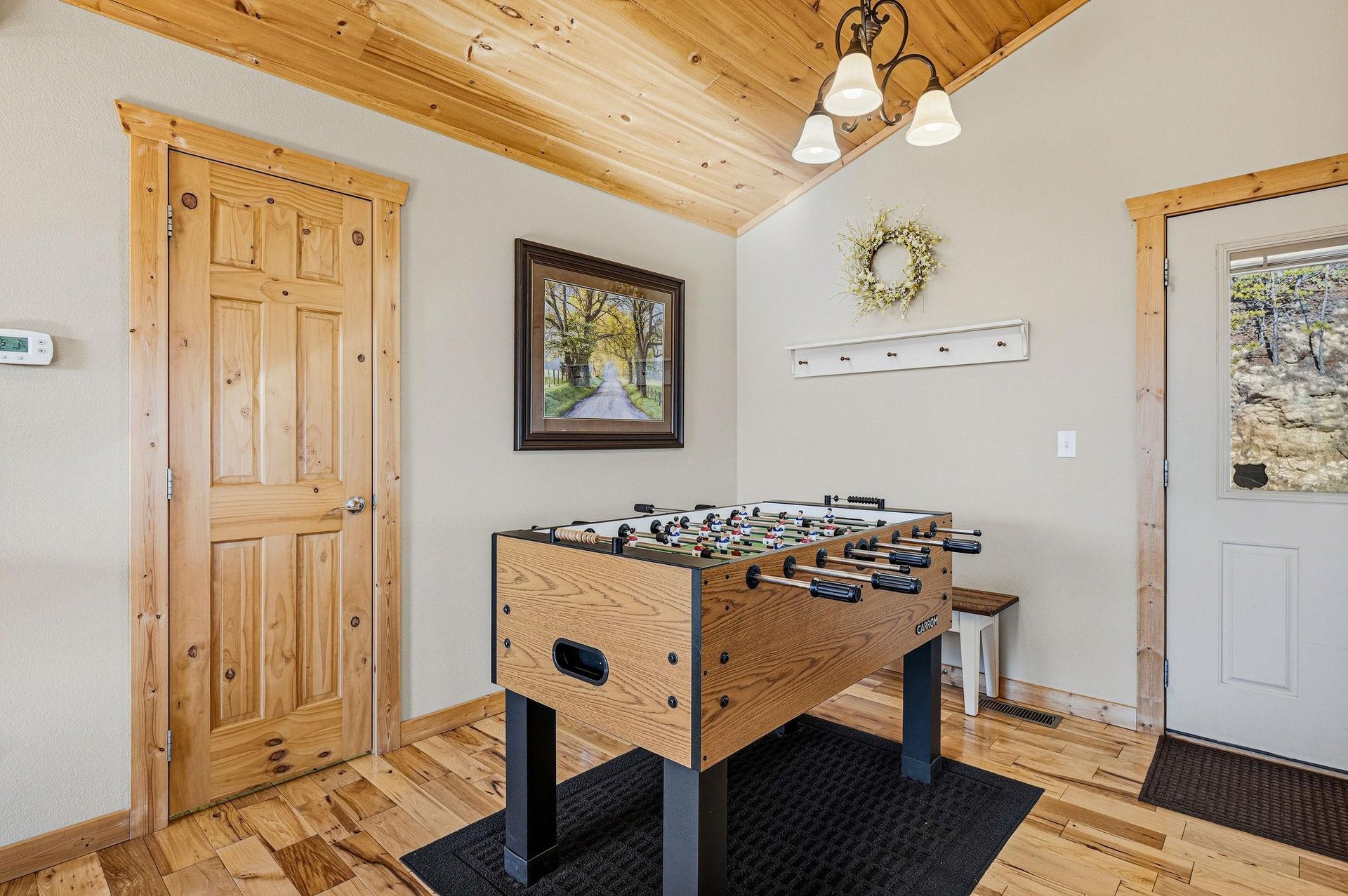 Challenge friends to exciting foosball matches in your dedicated game room with rustic wood beams and cozy mountain lodge charm.