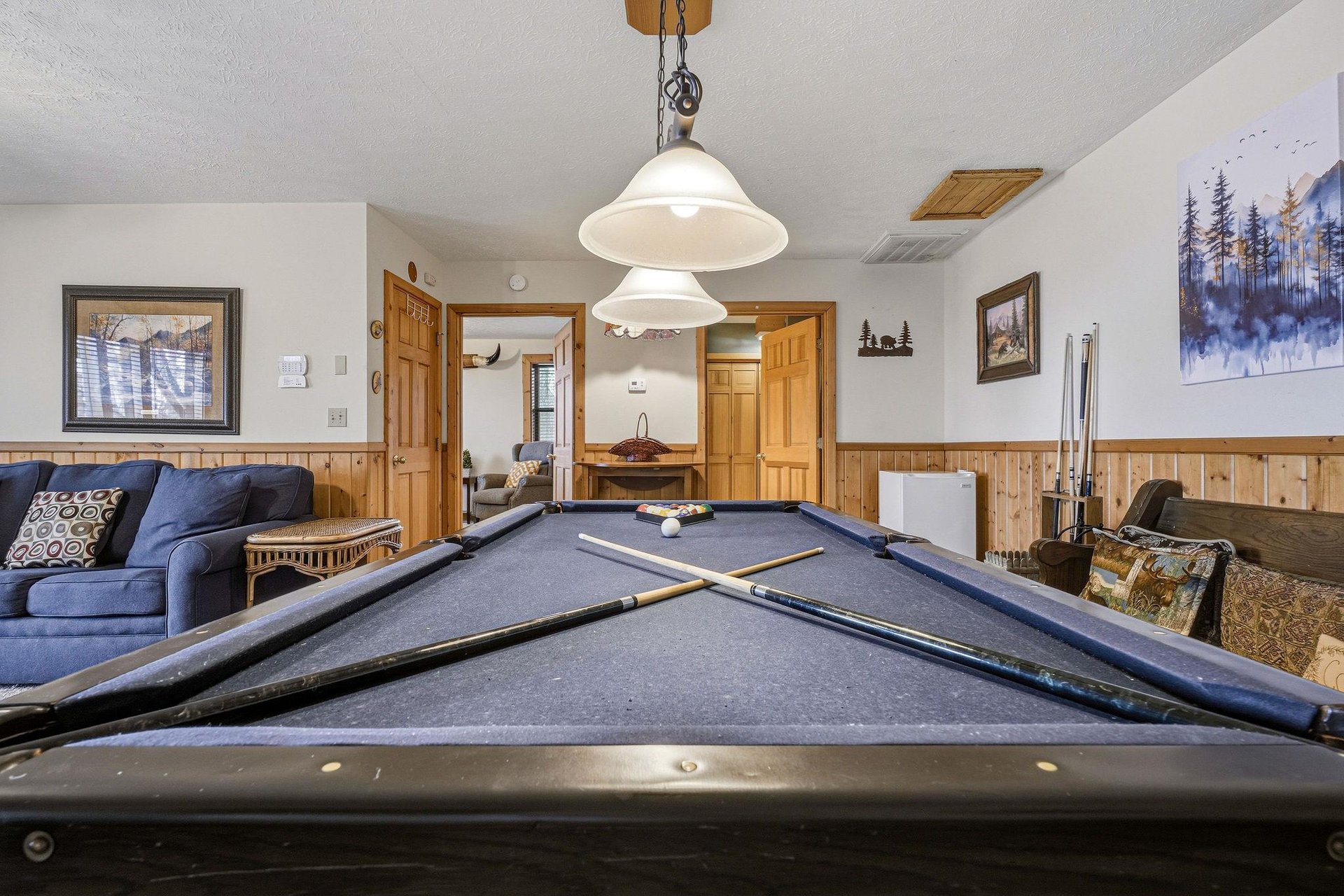 Challenge your group to a friendly game on this inviting pool table, surrounded by cozy seating for cheering on players.