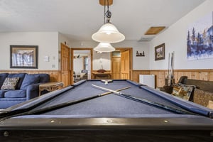 Challenge your group to a friendly game on this inviting pool table, surrounded by cozy seating for cheering on players.