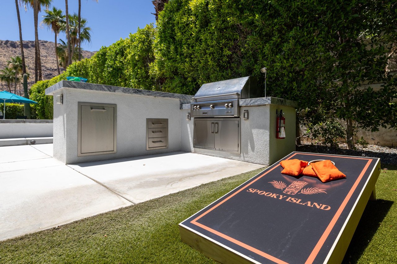 The side lawn is the perfect spot for a game of corn hole. Located next to the BBQ grill.