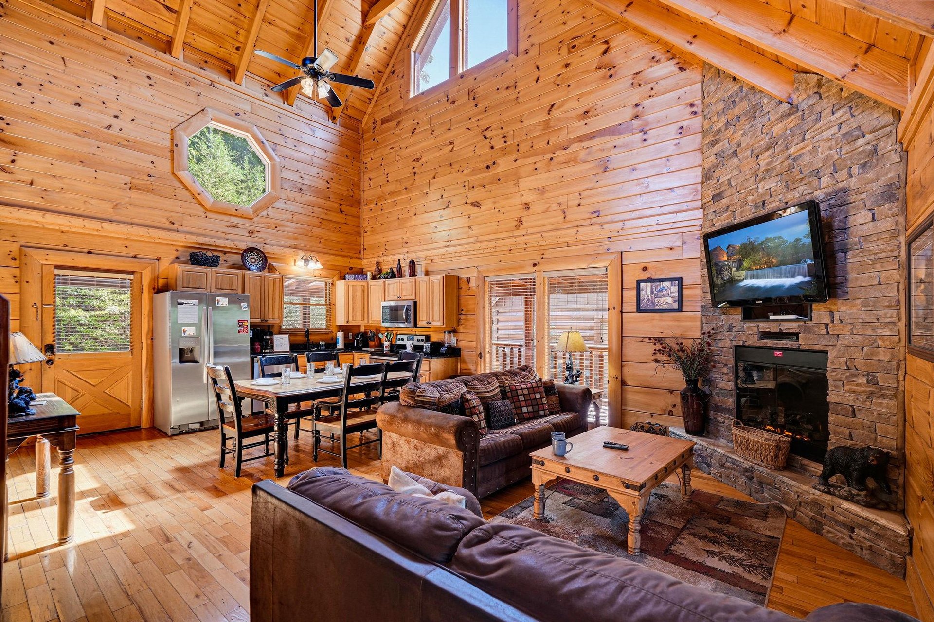 Step into warmth and rustic charm, where exposed beams frame your mountain retreat and a stone fireplace invites cozy evenings with loved ones.