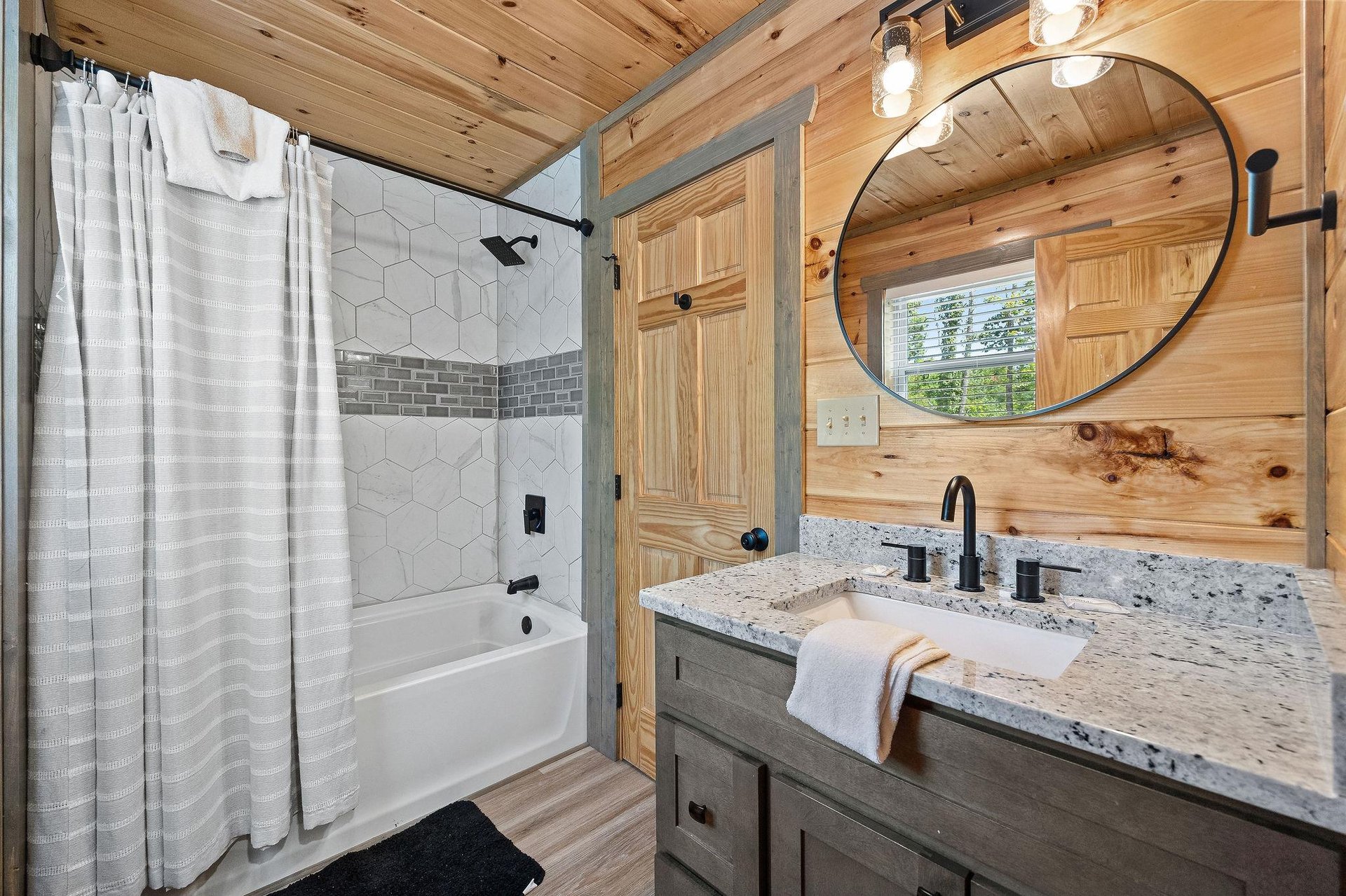 tile bathtub with shower and single vanity sink