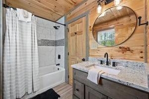 tile bathtub with shower and single vanity sink