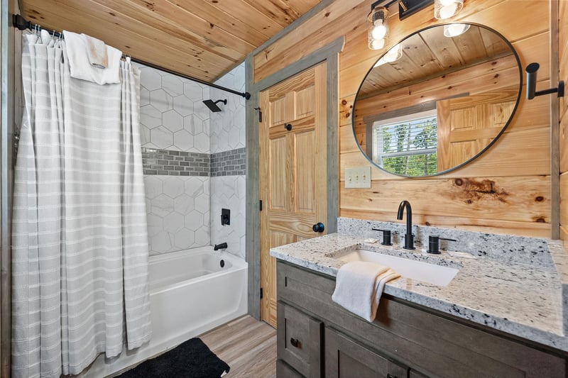 tile bathtub with shower and single vanity sink