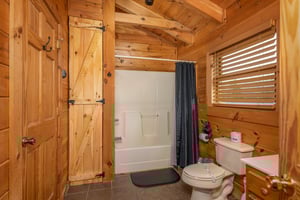 Tub and shower in a bathroom at Livin Simple, a 2 bedroom cabin rental located in Pigeon Forge