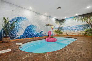 Escape to your own private indoor oasis Youll love lounging in the custom pool surrounded by vibrant tropical murals—perfect for yearround relaxation and fun.