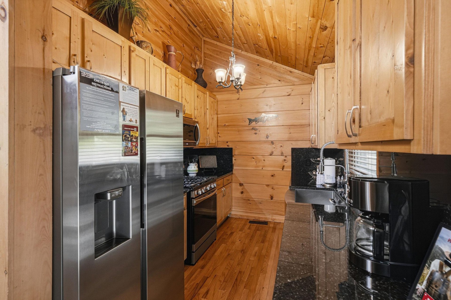 Prepare your favorite meals in this wellequipped kitchen with stainless steel appliances, granite counters, and warm wood cabinetry that sets a cozy, rustic tone for your stay.