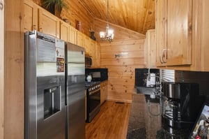 Prepare your favorite meals in this wellequipped kitchen with stainless steel appliances, granite counters, and warm wood cabinetry that sets a cozy, rustic tone for your stay.