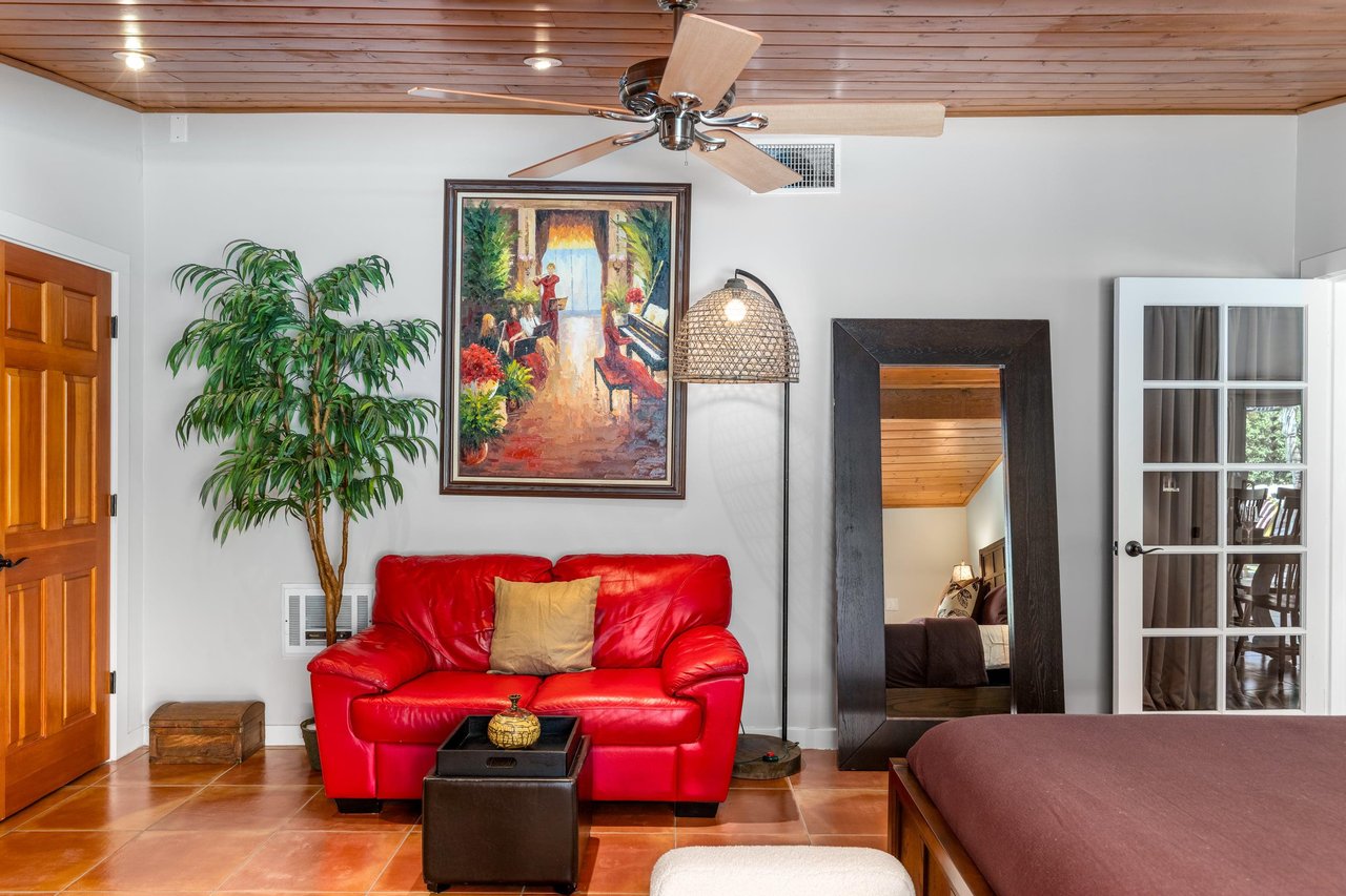 King bed, smart TV, patio access, and ensuite bathroom.