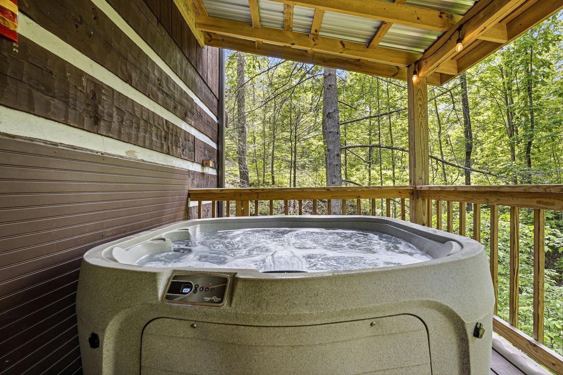Slip into the bubbling hot tub on your screened porch, where forest views and mountain air create a private sanctuary for soaking away the days cares.