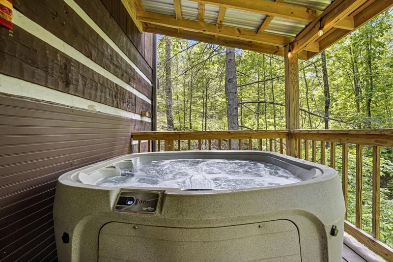 Slip into the bubbling hot tub on your screened porch, where forest views and mountain air create a private sanctuary for soaking away the days cares.