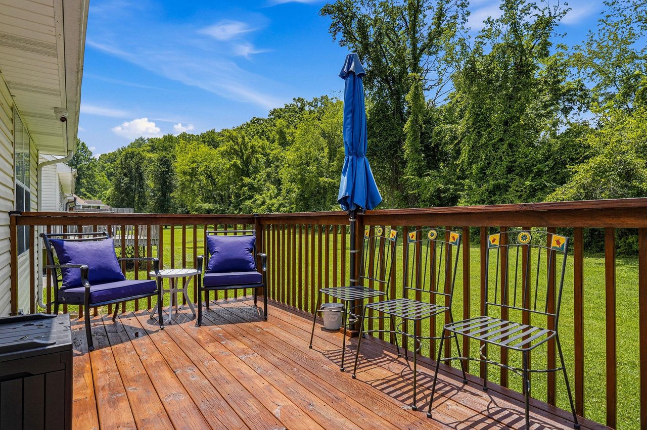 Step onto your private deck and unwind in comfortable seating surrounded by lush green trees. Enjoy morning coffee or evening relaxation with peaceful garden views stretching before you.