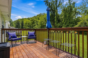 Step onto your private deck and unwind in comfortable seating surrounded by lush green trees. Enjoy morning coffee or evening relaxation with peaceful garden views stretching before you.