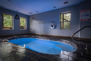 Unwind in your private indoor pool sanctuary, where warm blue waters and natural light create the perfect escape.