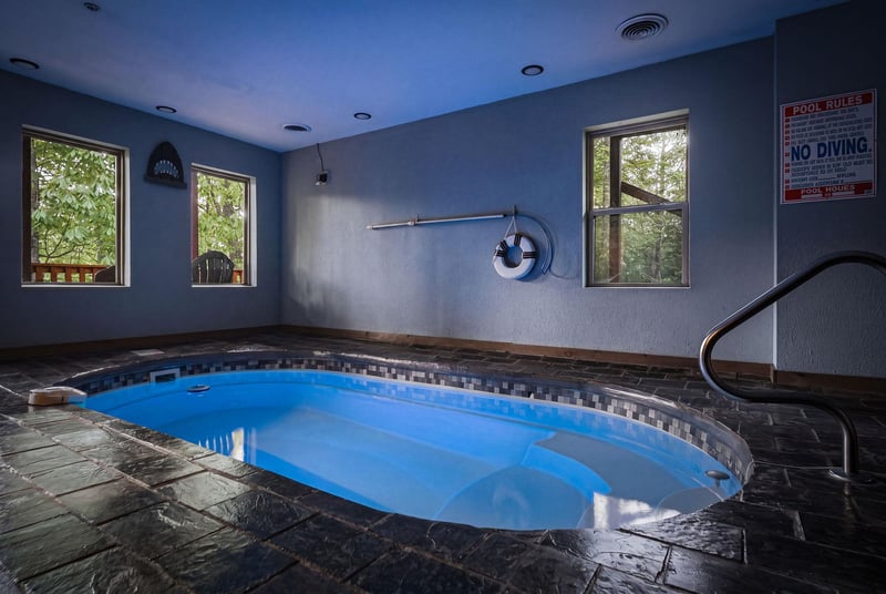 Unwind in your private indoor pool sanctuary, where warm blue waters and natural light create the perfect escape.
