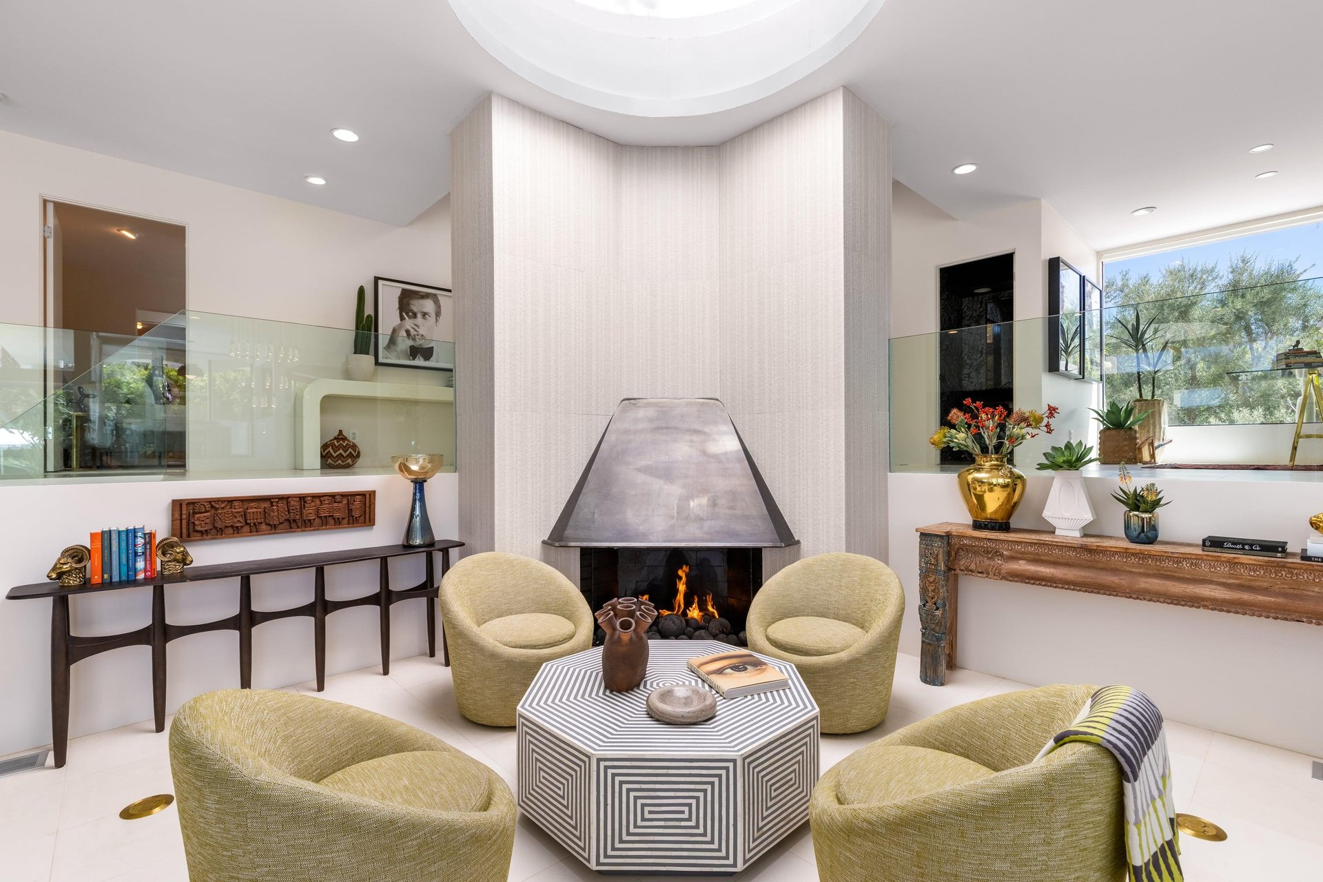 Between the dining room and living room is a sitting area with a stunning fireplace.