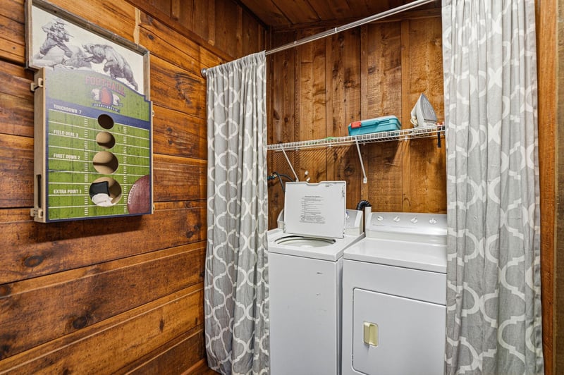 Your private laundry nook keeps essentials fresh with charming wood walls and convenient storage above the washer and dryer.