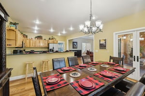 Gather around this spacious dining table where your group can share meals and make memories together in the warmth of this inviting openconcept space.