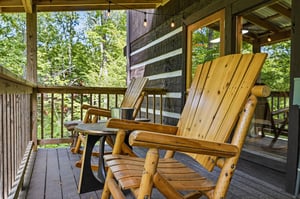 Settle into these handcrafted wooden chairs and enjoy your morning coffee surrounded by peaceful forest views. Your private covered deck is perfect for unwinding after a day of adventure.
