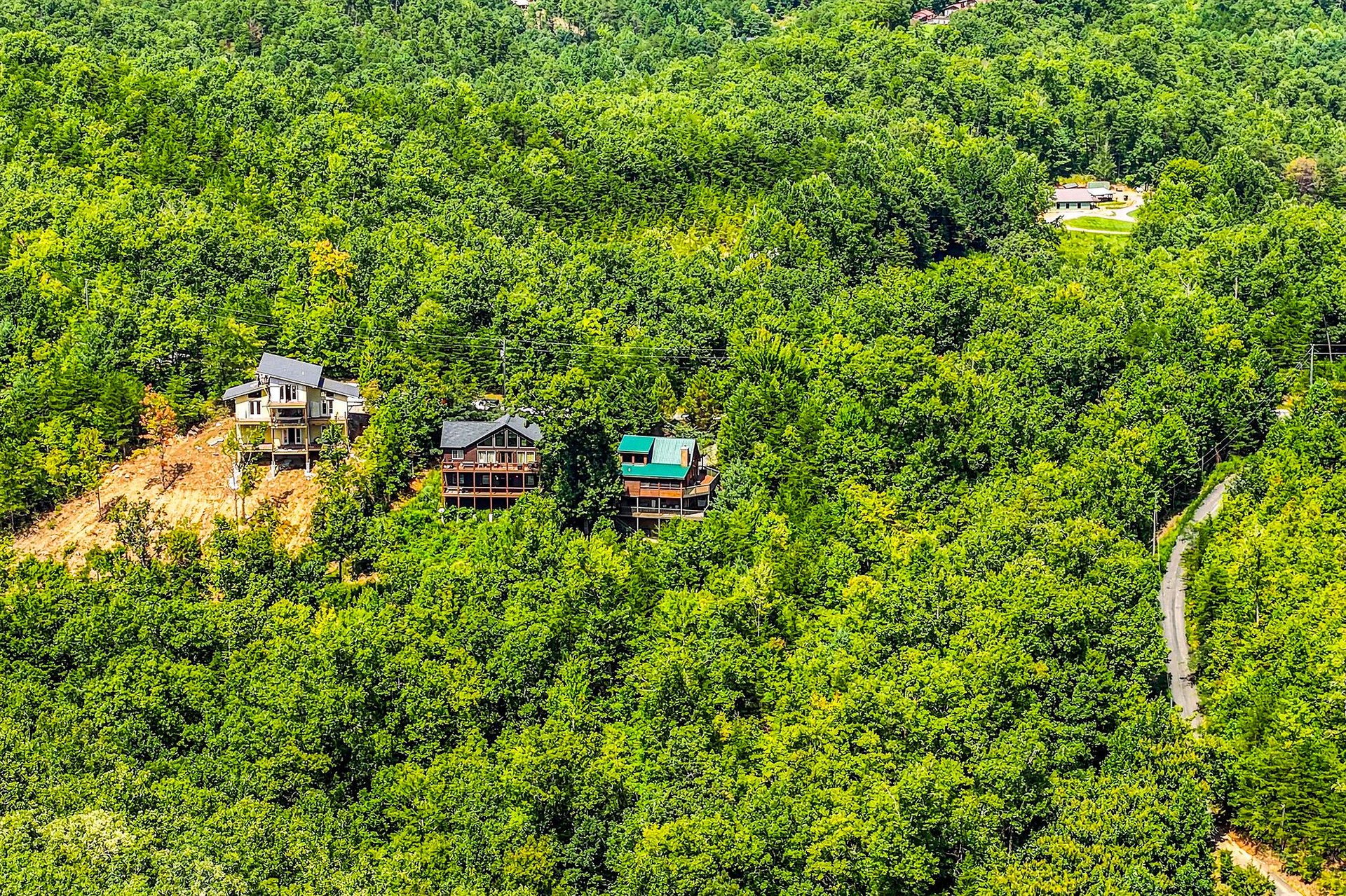 Nestled among lush green hillsides, these charming cabins offer a peaceful mountain retreat surrounded by natures beauty.