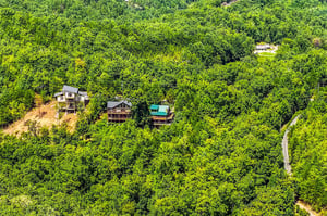 Nestled among lush green hillsides, these charming cabins offer a peaceful mountain retreat surrounded by natures beauty.