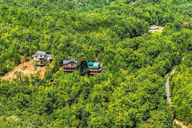Nestled among lush green hillsides, these charming cabins offer a peaceful mountain retreat surrounded by natures beauty.