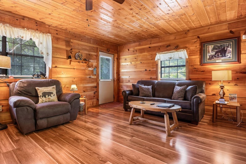 Living room with sofa and recliner at Beary Good Time, a 1bedroom cabin rental located in Pigeon Forge