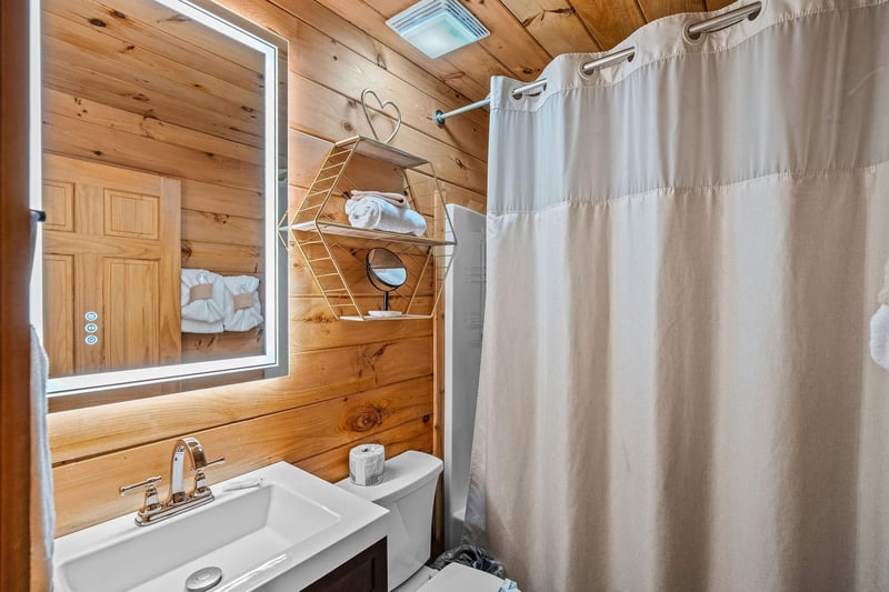Full bathroom with lit mirror