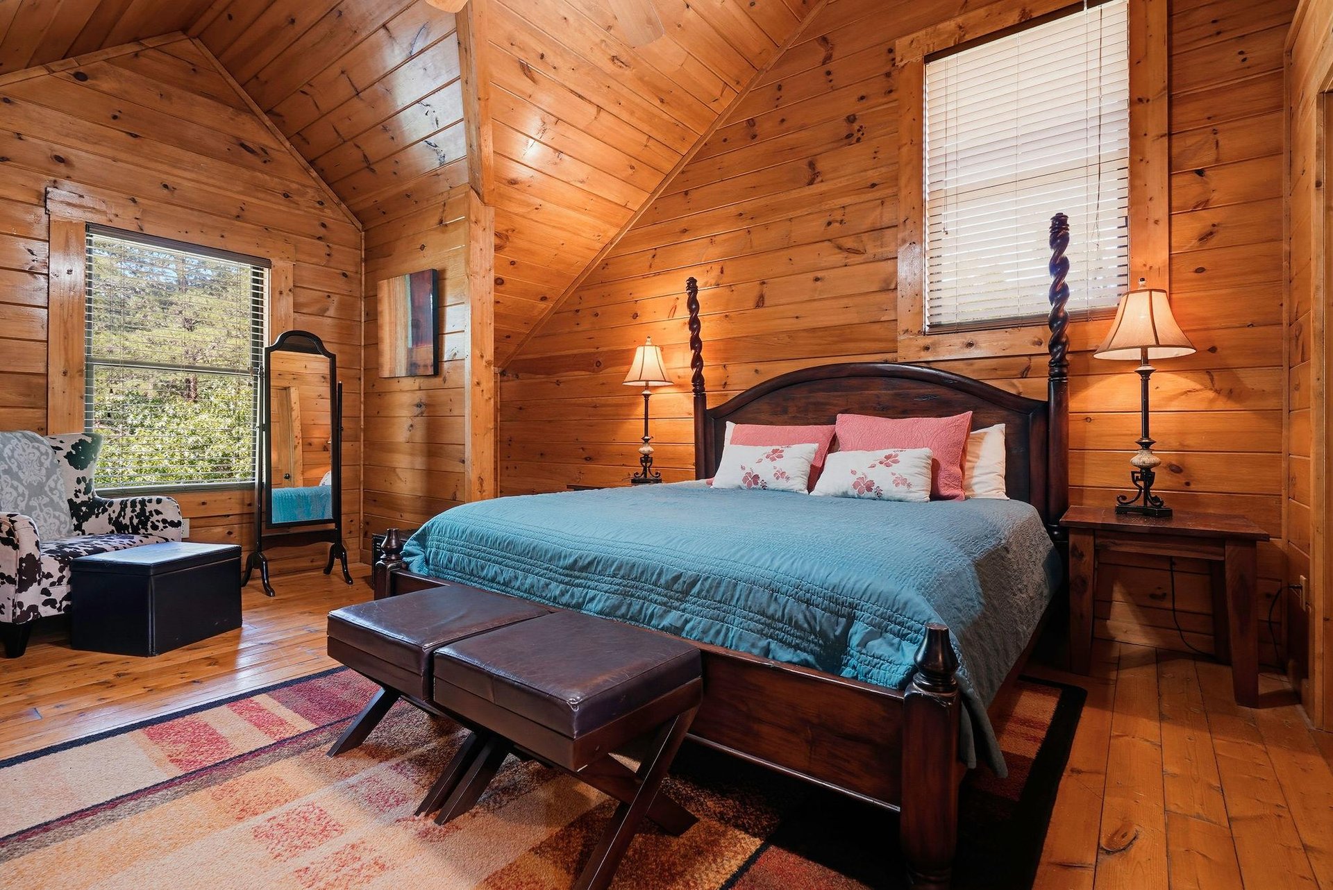 Sink into the cozy warmth of your cabin bedroom, wrapped in natural wood and soft lighting. Picture yourself resting in this inviting space after a day of exploration.